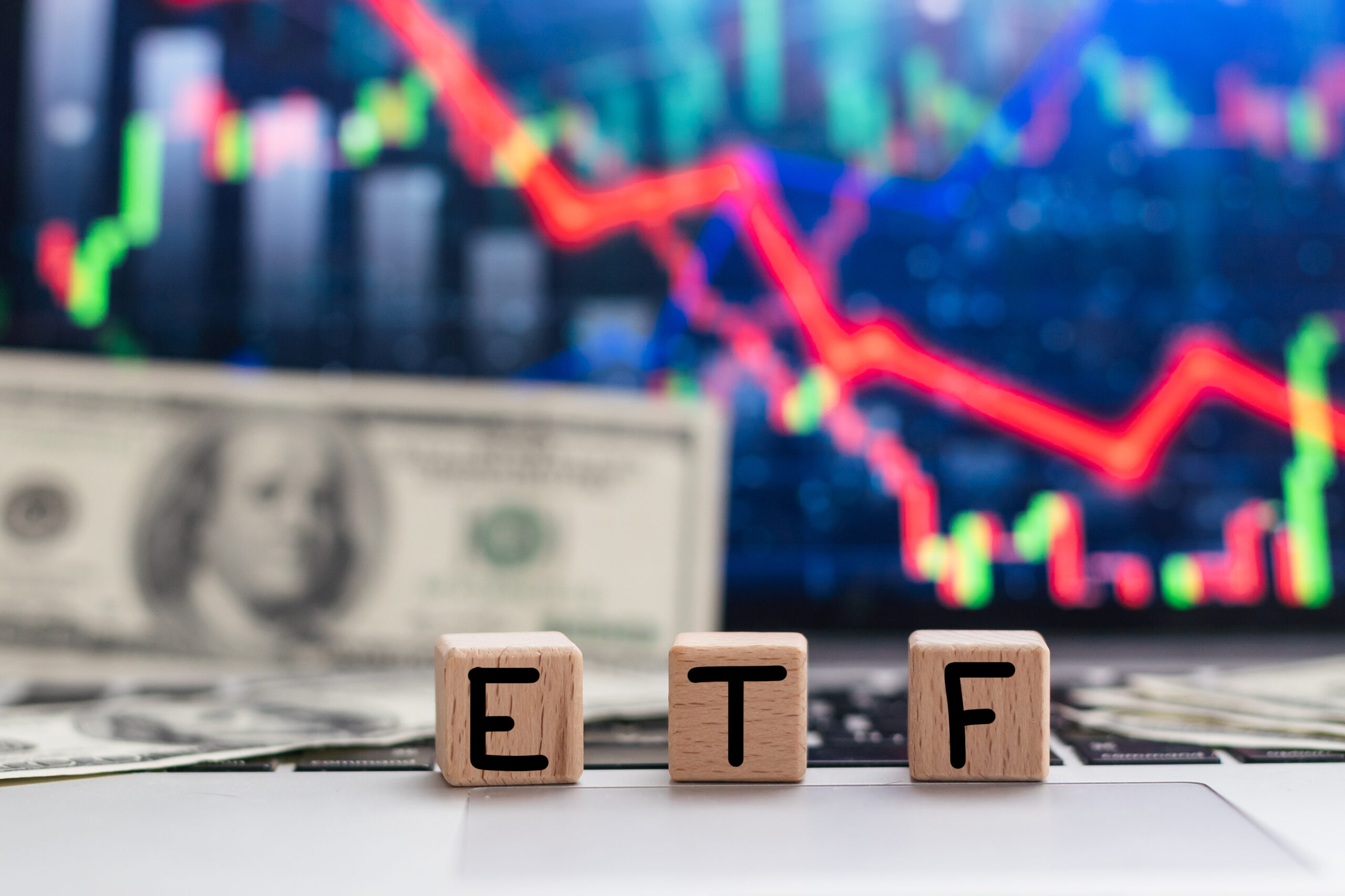 ETF - stock exchange text fund on wooden cubes, cubes lie on a financial chart