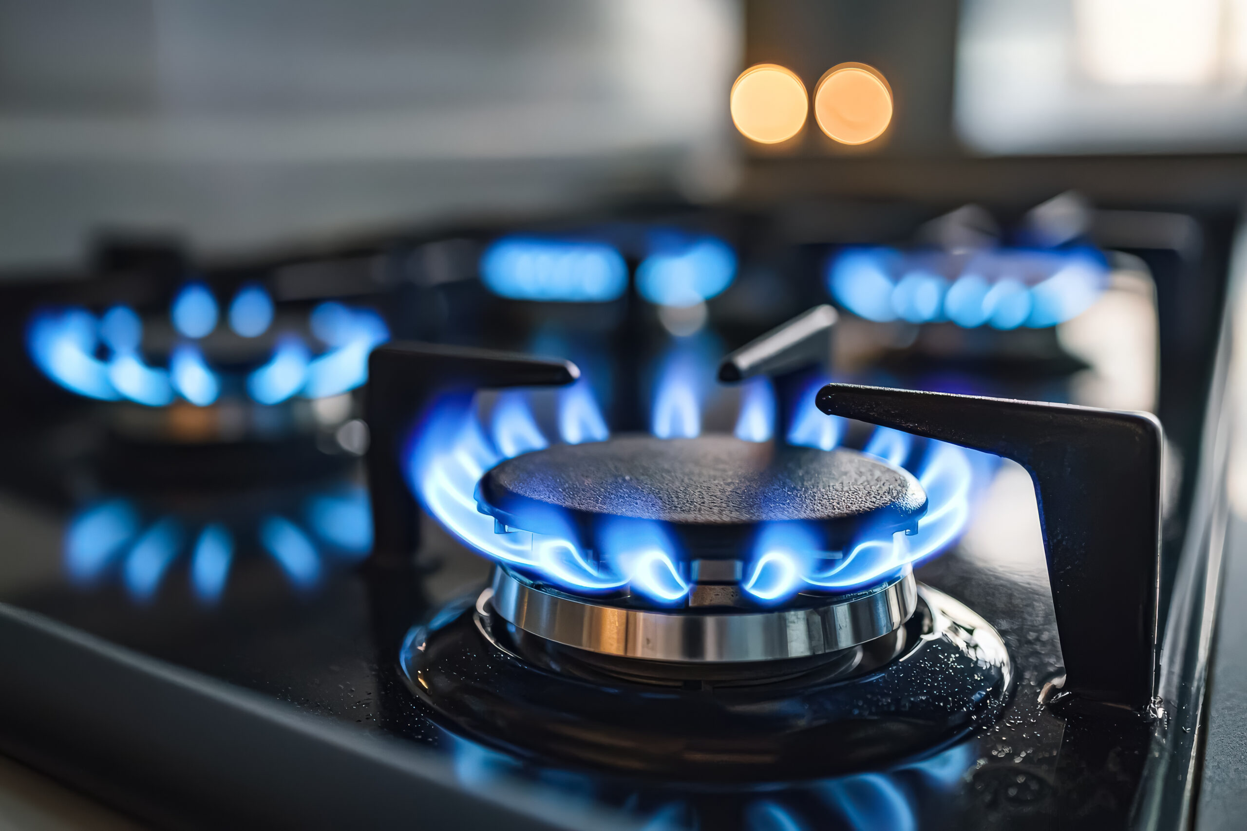 Stove burner is lit up with blue flames