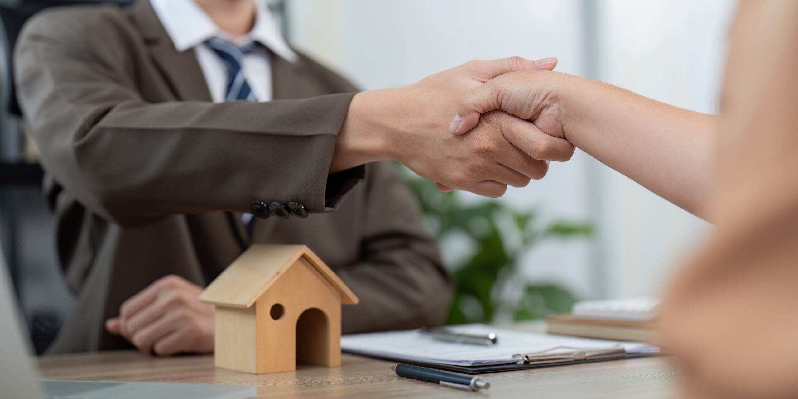 Trustworthy Real Estate Agent Concluding Deal with Client Through Solid Handshake